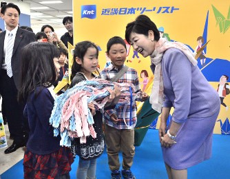 子どもたちから折り鶴を受け取る小池百合子都知事（画像：毎日新聞社提供）