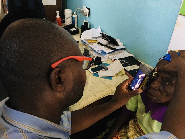 Local medical staff diagnosing a patient in rural clinic Malawi